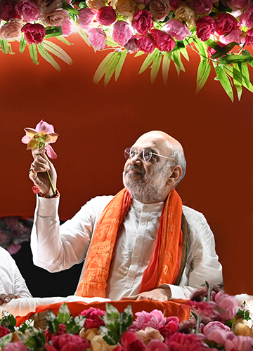 Flower power: Amit Shah holds up a lotus at a rally in Bengal | Salil Bera
