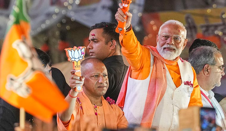 Double engine: Modi with Yogi Adityanath during a roadshow in Varanasi | PTI