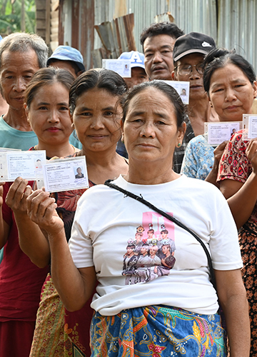 Myanmarese refugees in Phaikoh village show their identity cards.
