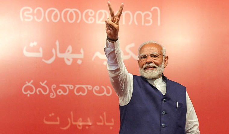 Coalition challenge: Narendra Modi during his victory speech on June 4. In the background is the message ‘Thank you, India’ in several Indian languages | PTI