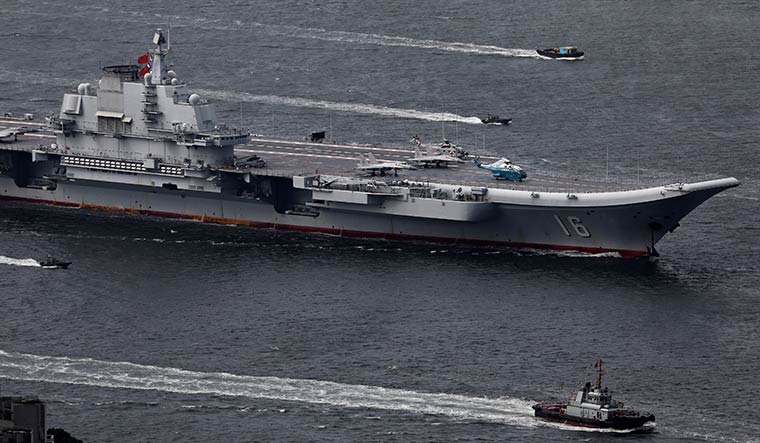 Action stations: Liaoning, China’s first aircraft carrier, sails into Hong Kong | AP