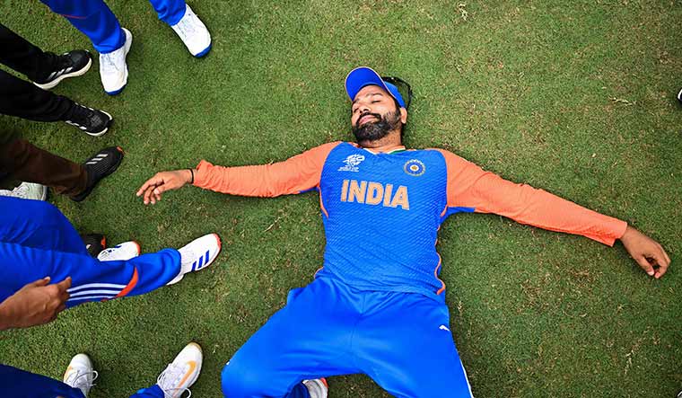 Hitman’s high: Rohit Sharma lays on the ground after India won the final of the T20 World Cup | AFP