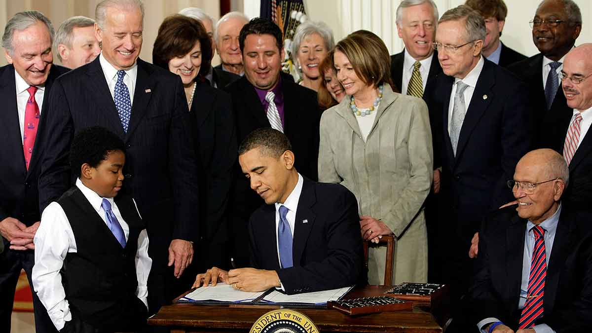 Signature achievement: Nancy Pelosi (second from right), Joe Biden and other senior leaders with president Barack Obama as he signs the Affordable Care Bill into law at the East Room of the White House | AP