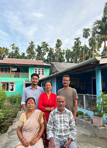 Friendly neighbours: Robin Datgiri (standing on the right) with family at his home in Datgiri, Assam.