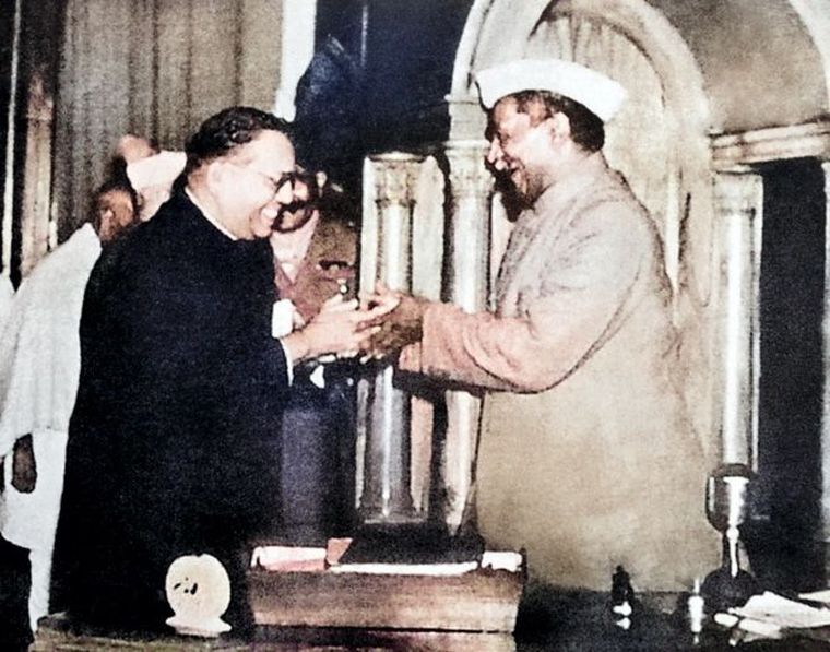 All smiles: Chairman of the drafting committee Dr B.R. Ambedkar hands over the Constitution to Dr Rajendra Prasad.