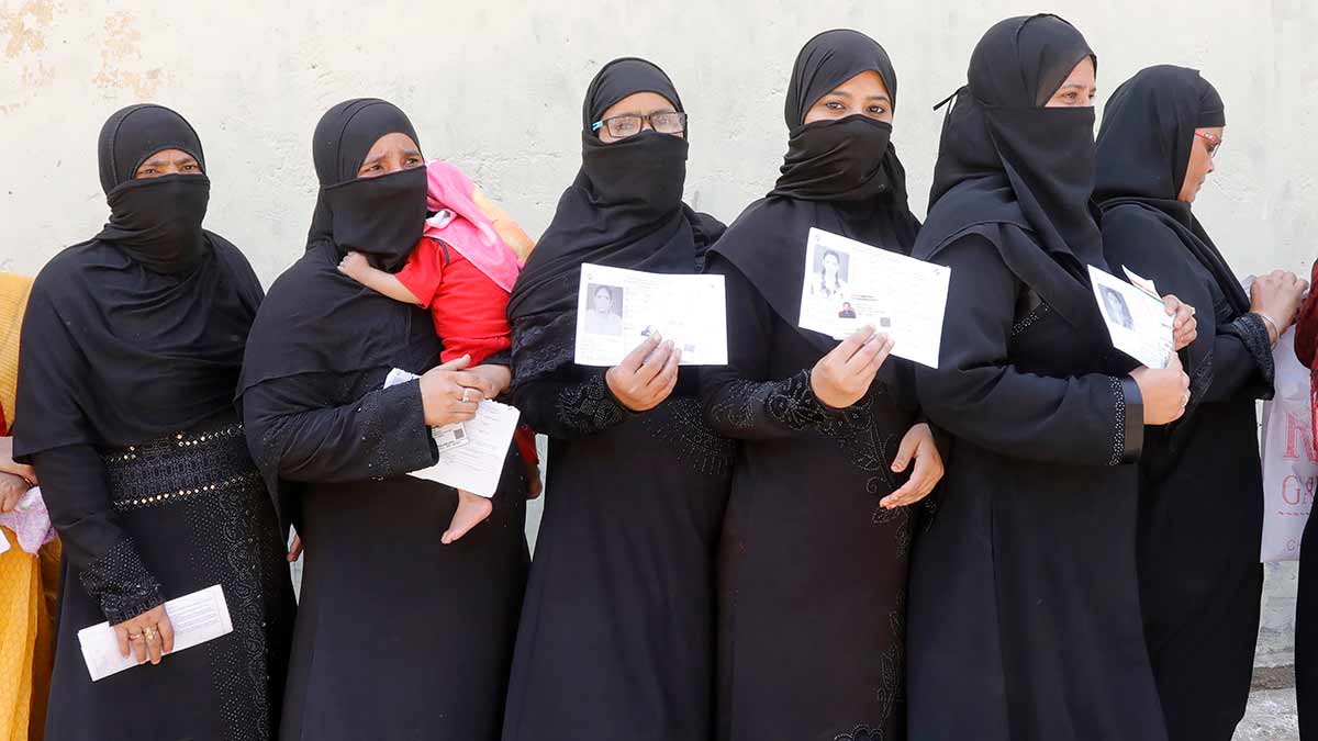 Exercising their right: A file photo of Muslim women waiting outside a polling station in Ayodhya | Pawan Kumar