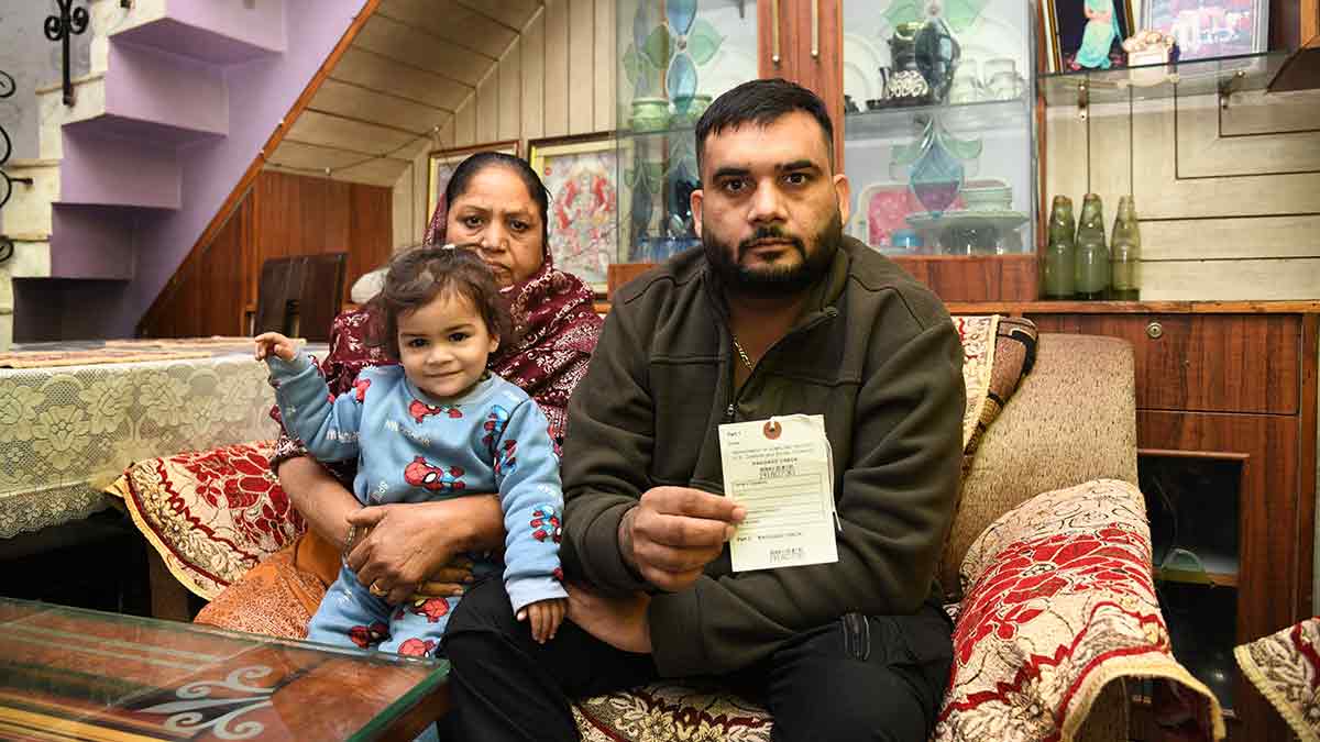 Heartbreak highway: Rakinder Singh, one of the deportees from the US, shows the deportation tag on his bag. He is with his daughter and mother at his home at Gulmarg Avenue, Ladhewali, Jalandhar | Sanjay Ahlawat