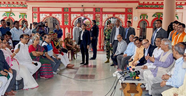 Reaching out: Yunus interacts with the Hindu community at the Dhakeshwari Temple in Dhaka | PTI