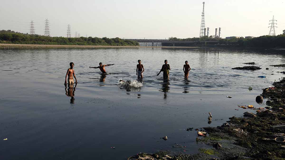 No child’s play: Children swim in the Yamuna, despite the filth nearby, near ITO barrage in New Delhi | Sanjay Ahlawat