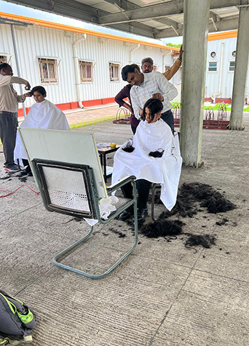 Women cadets have their heads shaven
