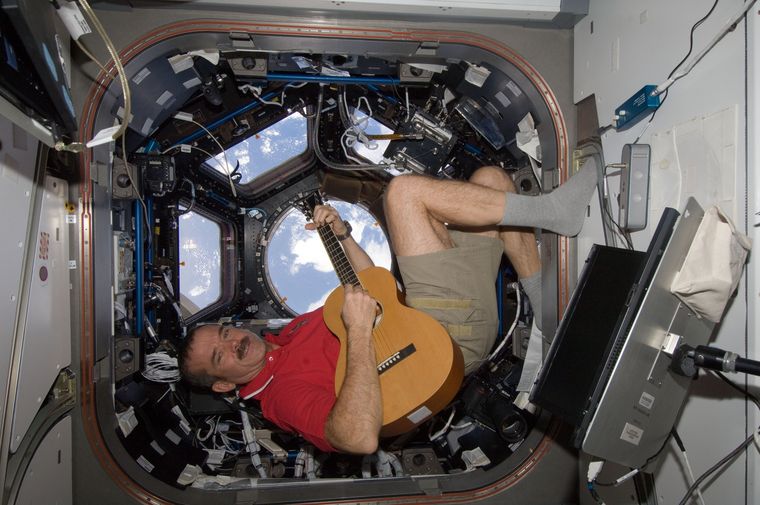Canadian astronaut Chris Hadfield plays guitar floating in the “Cupola” of the ISS | NASA