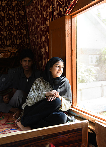When grief finds voice: Namrat, 17, with her brother at their one-room tin shed in Baramulla. Their grandfather was gunned down by terrorists in 1994 | Sanjay Ahlawat