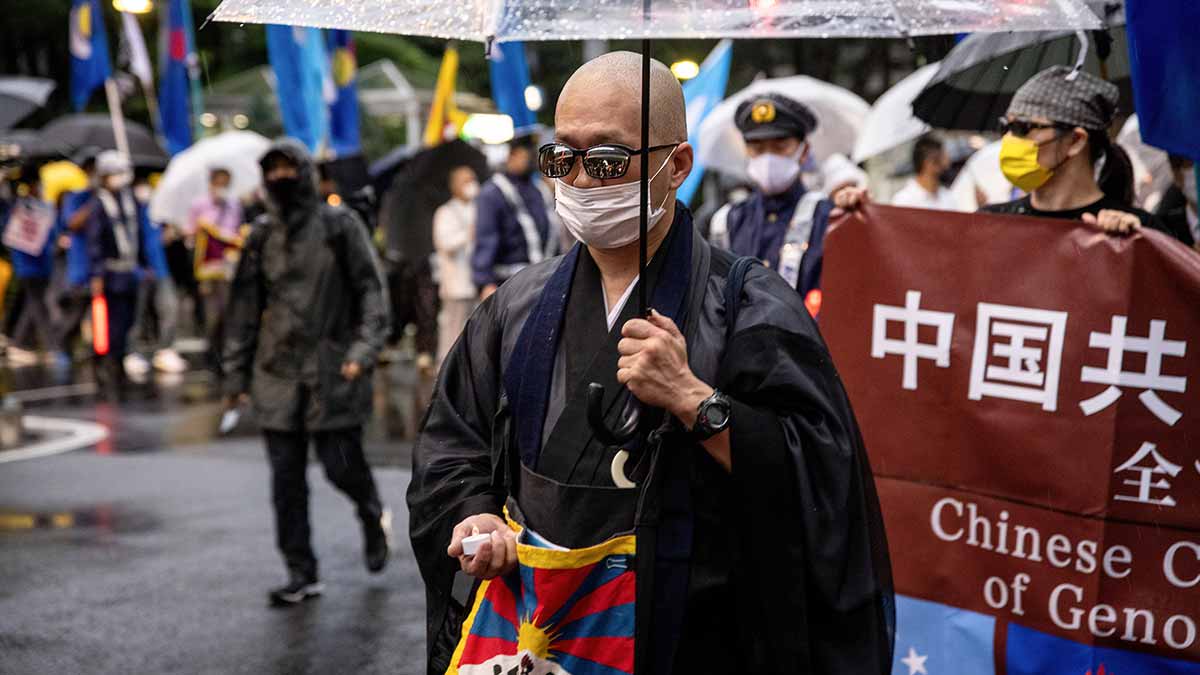 Shared ethos: A monk with the Tibetan flag at a pro-democracy protest in Tokyo | Getty Images