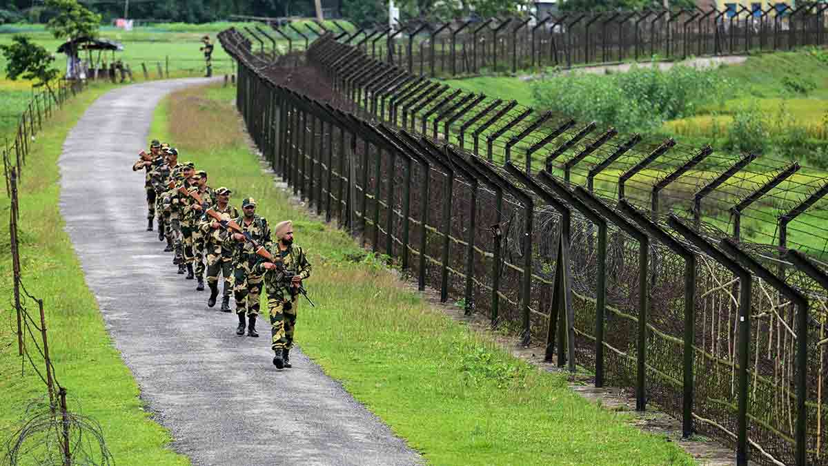 Safe and secure: BSF personnel patrol along the border fence at the Bangladesh border in Golakganj, Dhubri district, Assam | AFP