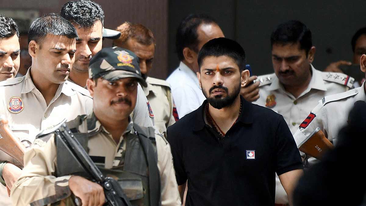 Plans from the prison: Policemen escort Lawrence Bishnoi to a court in Delhi in 2023 | Reuters