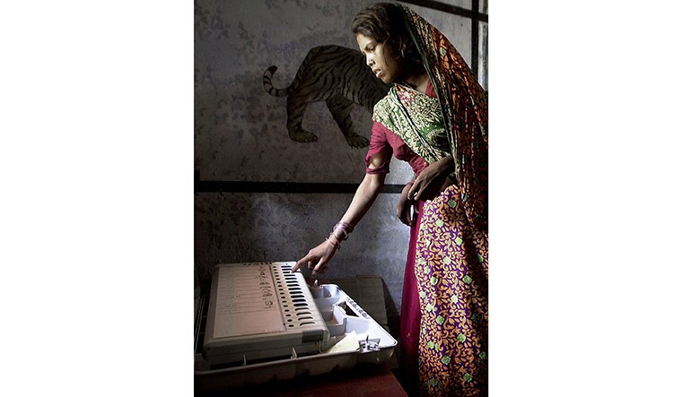 First-hand experience: A woman casts her vote using the electronic voting machine in a village near Bodh Gaya, some 150km south of Patna, during the 2004 Lok Sabha elections | AFP