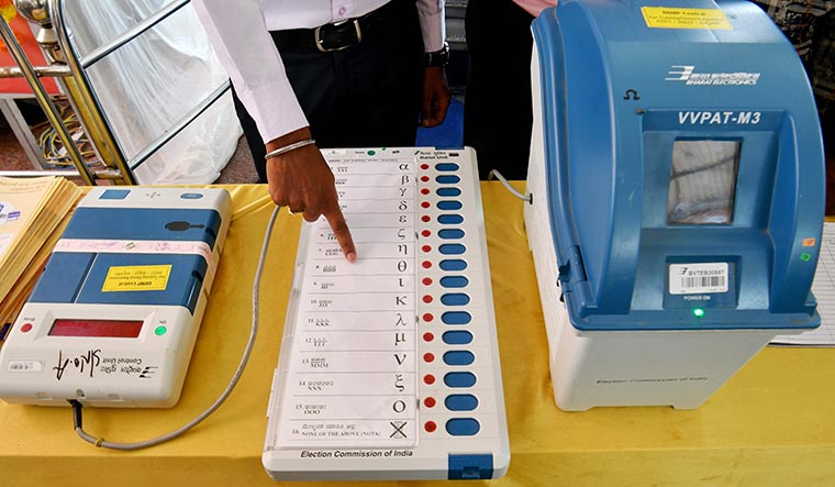 Teaching tech: An election official demonstrates the vote casting process to people as part of regional outreach in Bengaluru during the 2019 Lok Sabha election | AFP