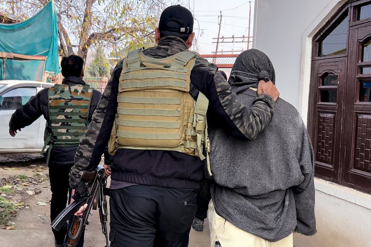 Rapid response: A suspect’s father being taken in for questioning in Pulwama | PTI