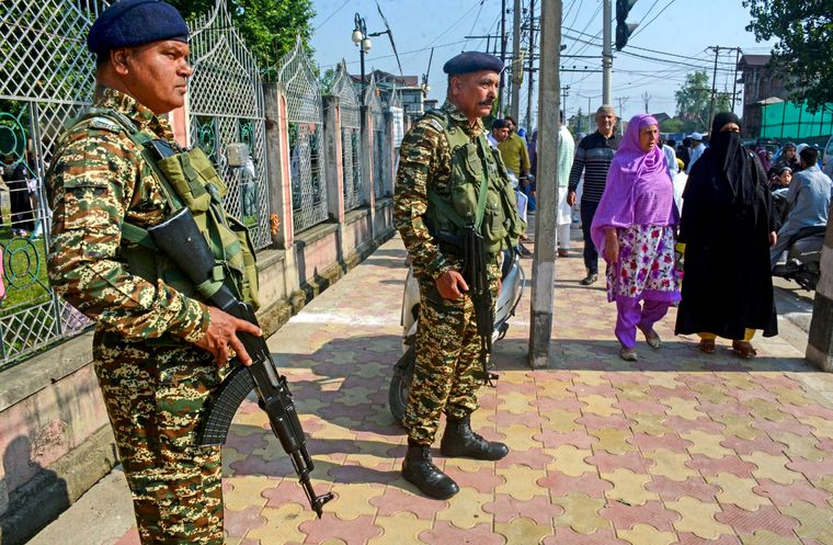 Keeping vigil: Security personnel stand guard outside Eidgah ground in Srinagar | PTI