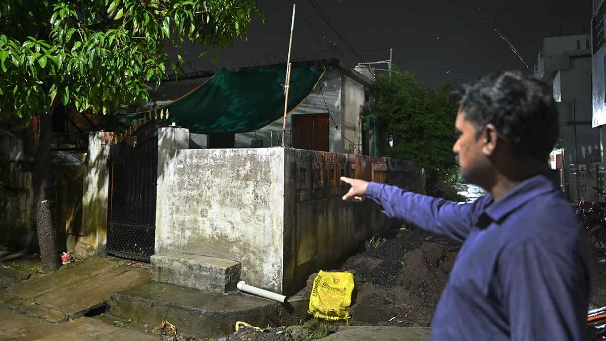 Shedding light: A Congress worker points to a house in Chandrapur district where 119 voters were registered | Amey Mansabdar