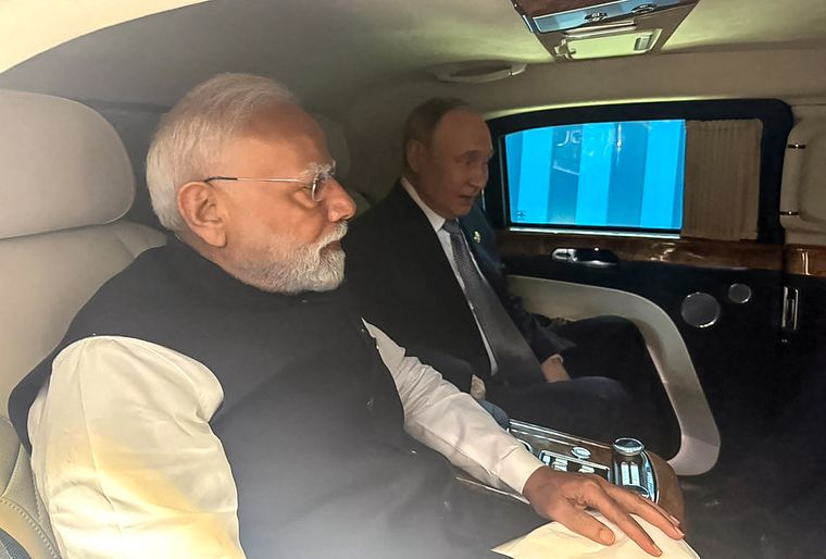 Two’s company: Prime Minister Modi and President Putin leave together for their bilateral meeting after attending the SCO summit | AFP