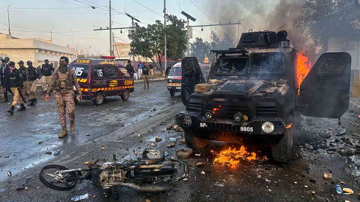 Flames of anger: Police and paramilitary personnel near an armoured vehicle that was set on fire during a protest in Karachi on March 1 over the killing of Iranian supreme leader Ayatollah Ali Khamenei | AP