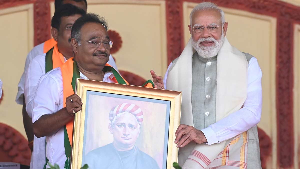Literary nod: Bhattacharya and Prime Minister Narendra Modi with a picture of Bengali writer Bankim Chandra Chattopadhyay, who wrote ‘Vande Mataram’, during a campaign event in Kolkata | Salil Bera