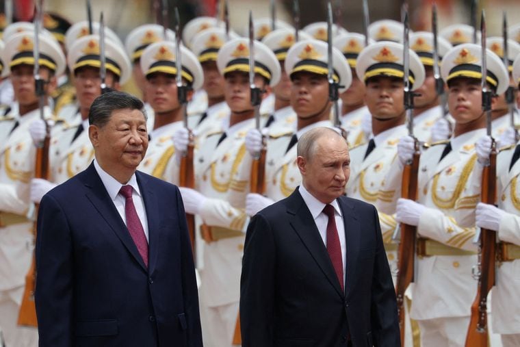 Balancing act: Presidents Xi Jinping and Vladimir Putin inspect an honour guard at the Great Hall of the People in Beijing on May 20 | Reuters