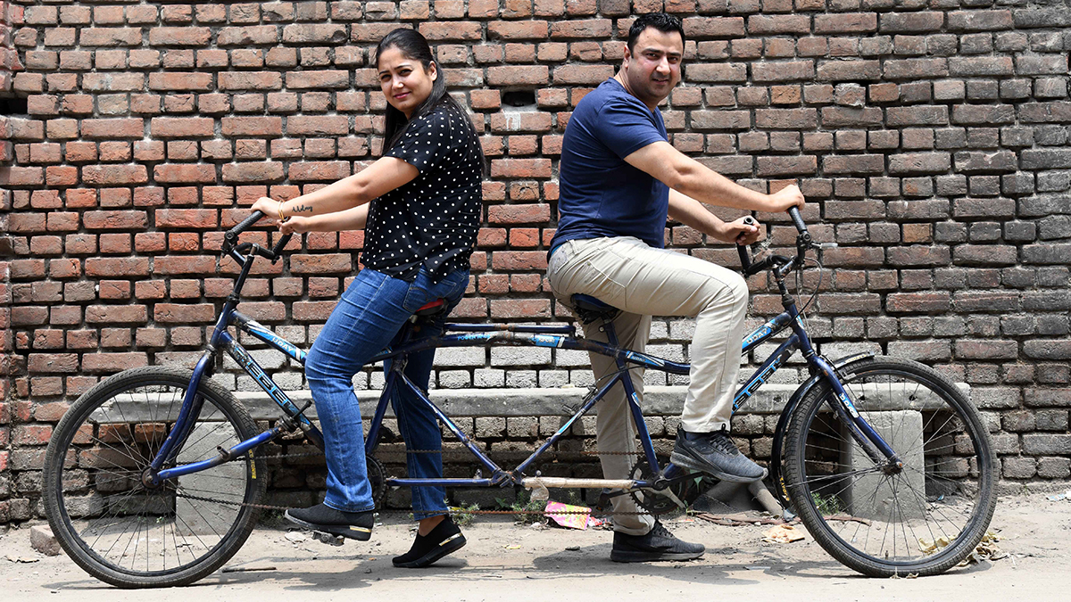 69-with-his-wife-Divya-on-a-reverse-tandem-bike 69-with-his-wife-Divya-on-a-reverse-tandem-bike