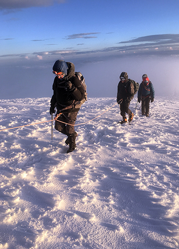 Top of the world: Krishna (middle) summits Cayambe mountain in Ecuador.