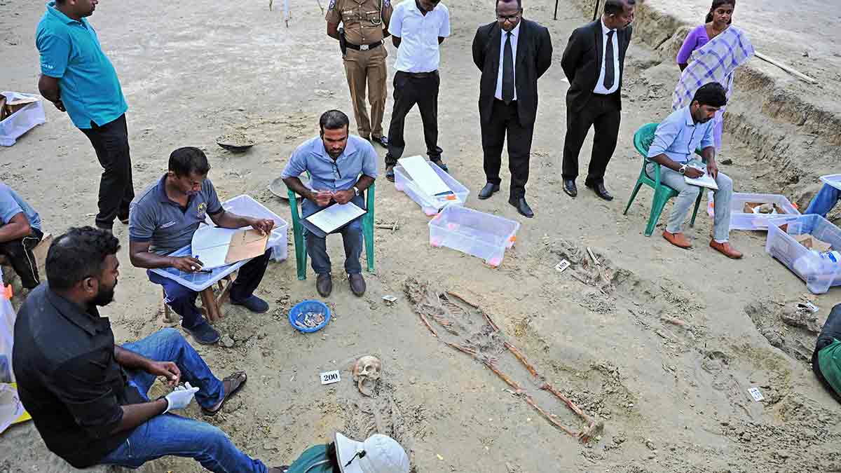 Workers at the mass grave in Jaffna; more than 200 skeletons have been dug up in recent months | Salil Bera
