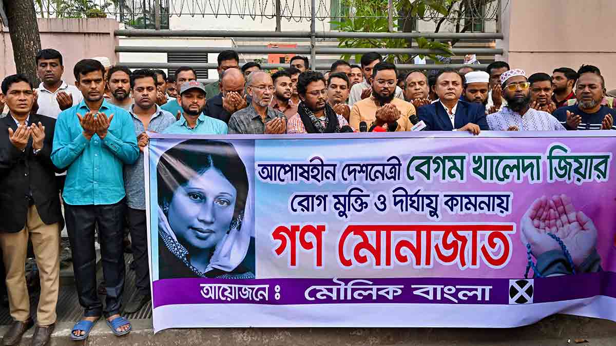 Divine assistance: Supporters of Begum Khaleda Zia pray for her recovery outside the Dhaka hospital where she is being treated | AFP
