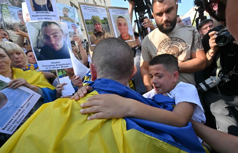 Freedom at last: Relatives hug a Ukrainian prisoner of war after his release on August 14 | AFP