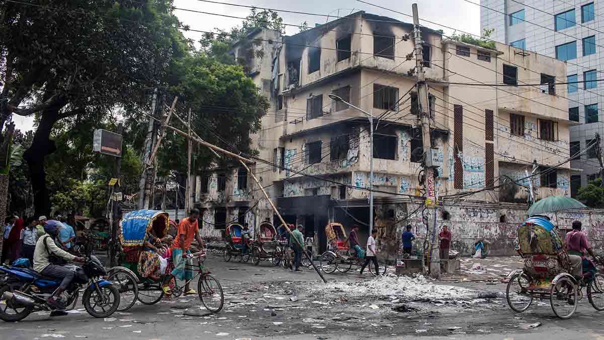 DHAKA, BANGLADESH - 2024/08/06: Smoke billows near burnt Awami League party office as anti-government protestors rally. (Photo by Sazzad Hossain/SOPA Images/LightRocket via Getty Images)