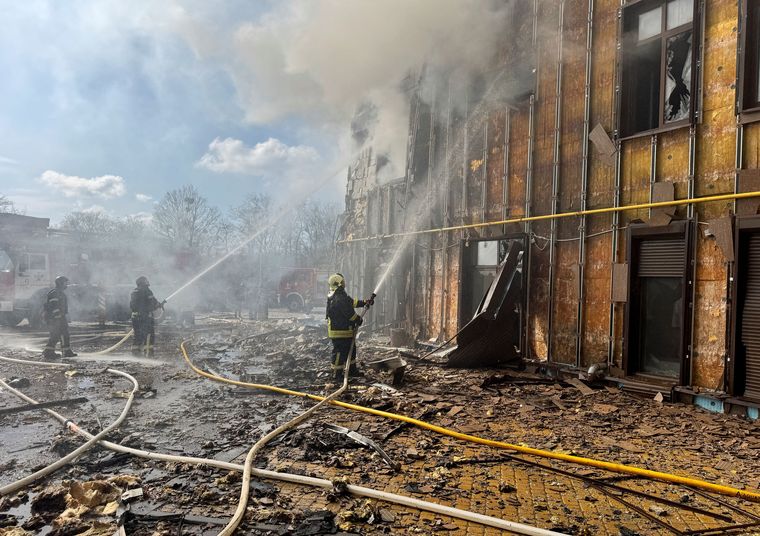 Firefighters work on an apartment building hit by a Russian drone in Kharkiv, Ukraine | Reuters