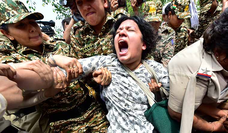 Fighting spirit: Police remove a protester outside the education ministry in Delhi during a demonstration against the NEET paper leak | Rahul R. Pattom