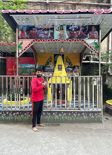 Trinath Baurusetty with the idol of Dhaka Thalli, a local deity, at the Telugu community colony in Dhaka.