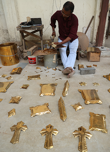 All in a day’s work: An employee works on motifs and other fittings for coffins | R.G. Sasthaa