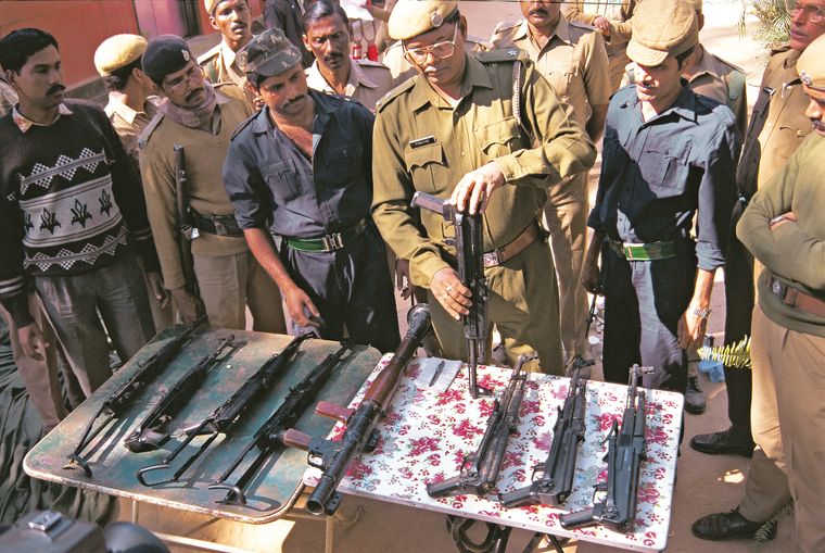 Unsolved mystery: Police with arms recovered from the drop sites | Getty Images