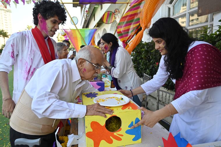 Fun and games: A grandpal takes part in an activity during the Holi celebration by The Goodfellows | Amey Mansabdar