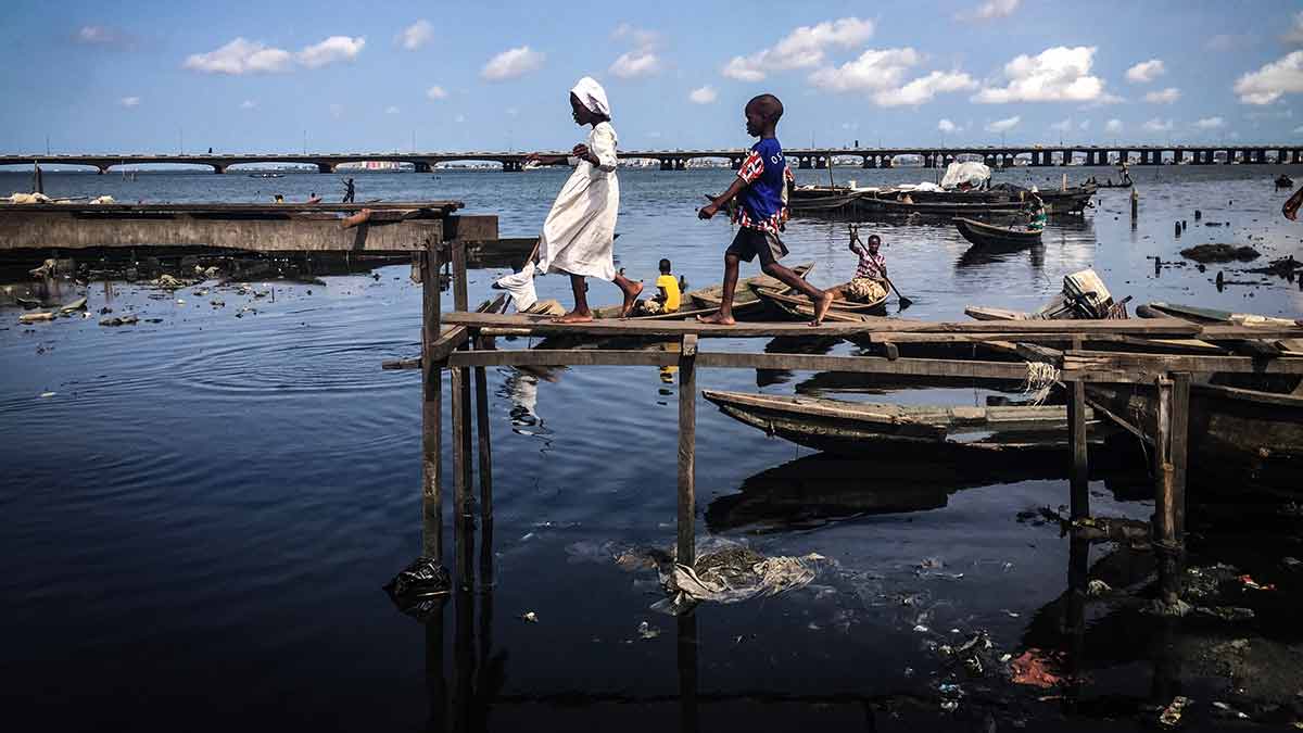 Walk of faith: A little girl in Makoko on her way to the church with her friend | Shutterstock