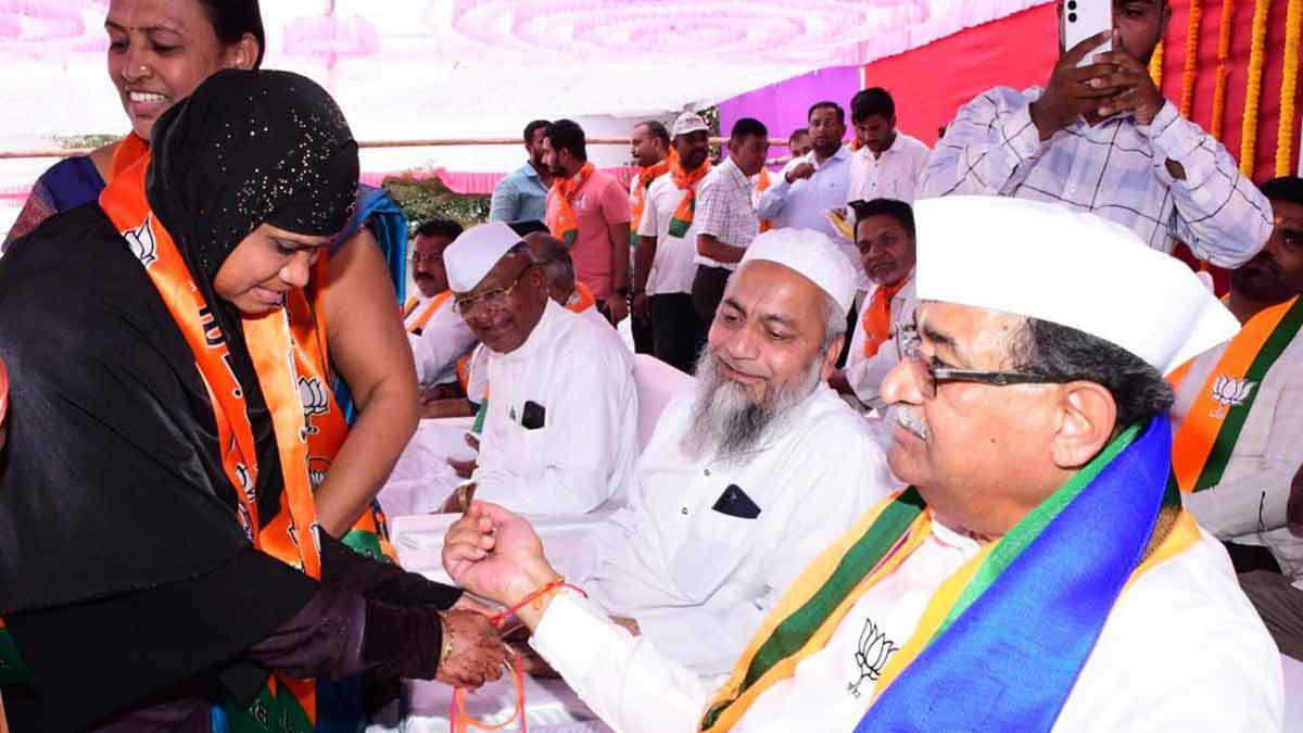 Fighting for his legacy: A woman ties a thread on the wrist of Radhakrishna Vikhe Patil.