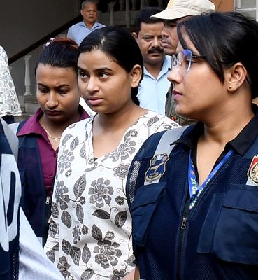 Sour note: Amritprava Mahanta (centre), a singer known to be a part of Zubeen’s extended musical circle, being brought to a court in Guwahati after her arrest | PTI