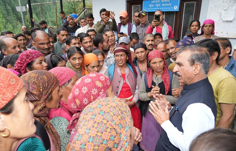 Reaching out: Sukhu interacts with victims of the cloudbursts in Mandi.