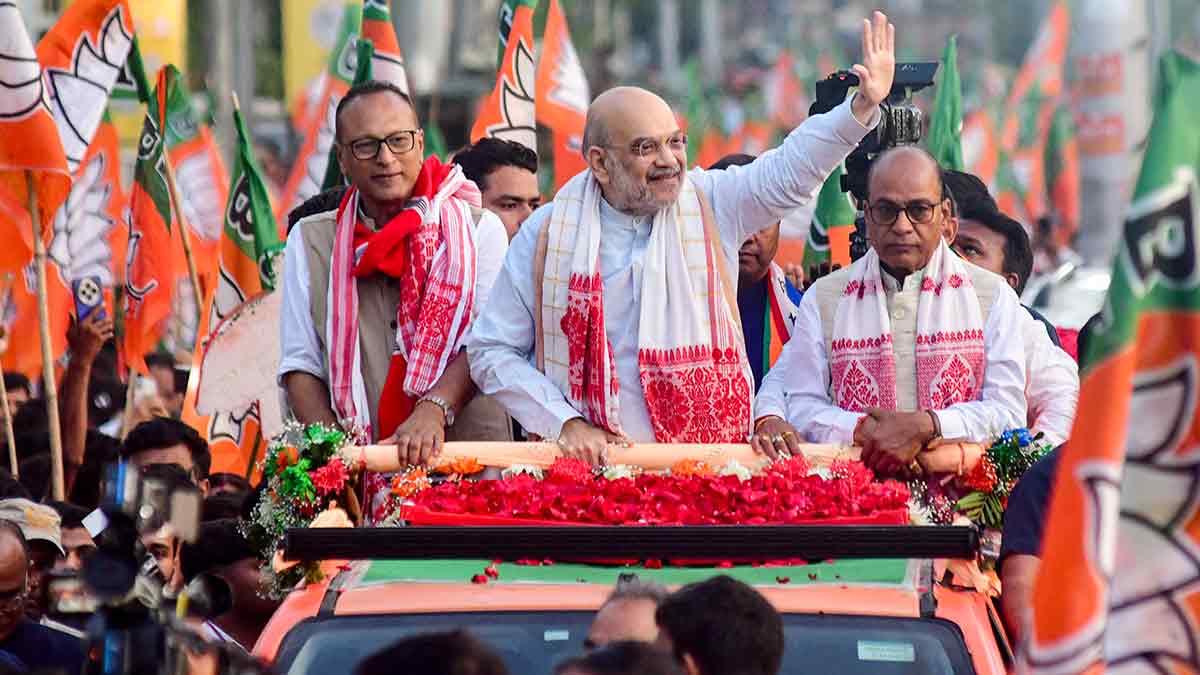 Winning formula: Union Home Minister Amit Shah with NDA candidates Pradyut Bordoloi (left) and Vijay Kumar Gupta (right) at a roadshow in Guwahati | PTI