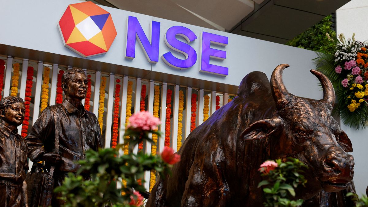 (File) Statues of people and a bull next to the logo of the National Stock Exchange (NSE) in Mumbai | Reuters