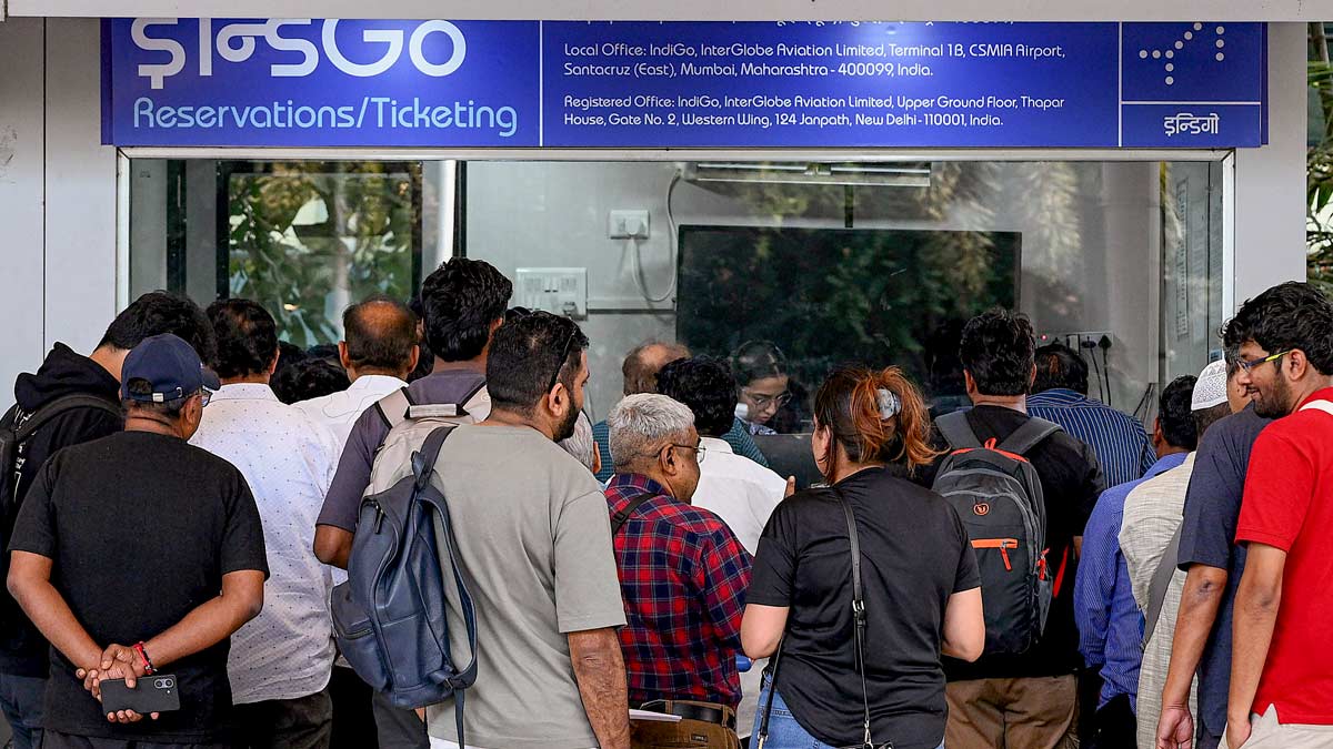 Passengers crowd an IndiGo reservations and ticketing counter after several flights were cancelled at Chhatrapati Shivaji Maharaj International Airport, in Mumbai | PTI