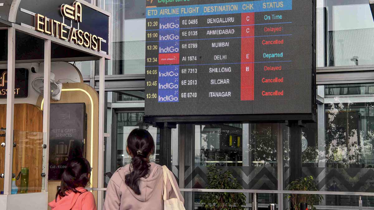 Passengers check updates on the display board amid IndiGo flight disruptions, at Netaji Subhash Chandra Bose International Airport in Kolkata | PTI