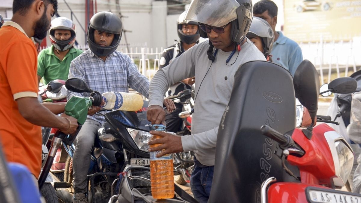 People queue up at a petrol pump amid rumours of fuel shortage in the wake of the Middle East conflict, in Guwahati, Assam, on March 26 | PTI
