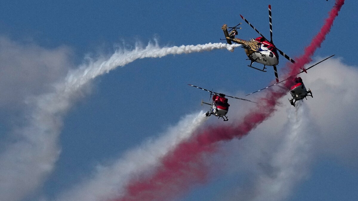 Sarang, a helicopter display team, performs in a formation during 93rd Indian Airforce Day celebration in Guwahati, India, Sunday, Nov. 9, 2025. (AP Photo/Anupam Nath)